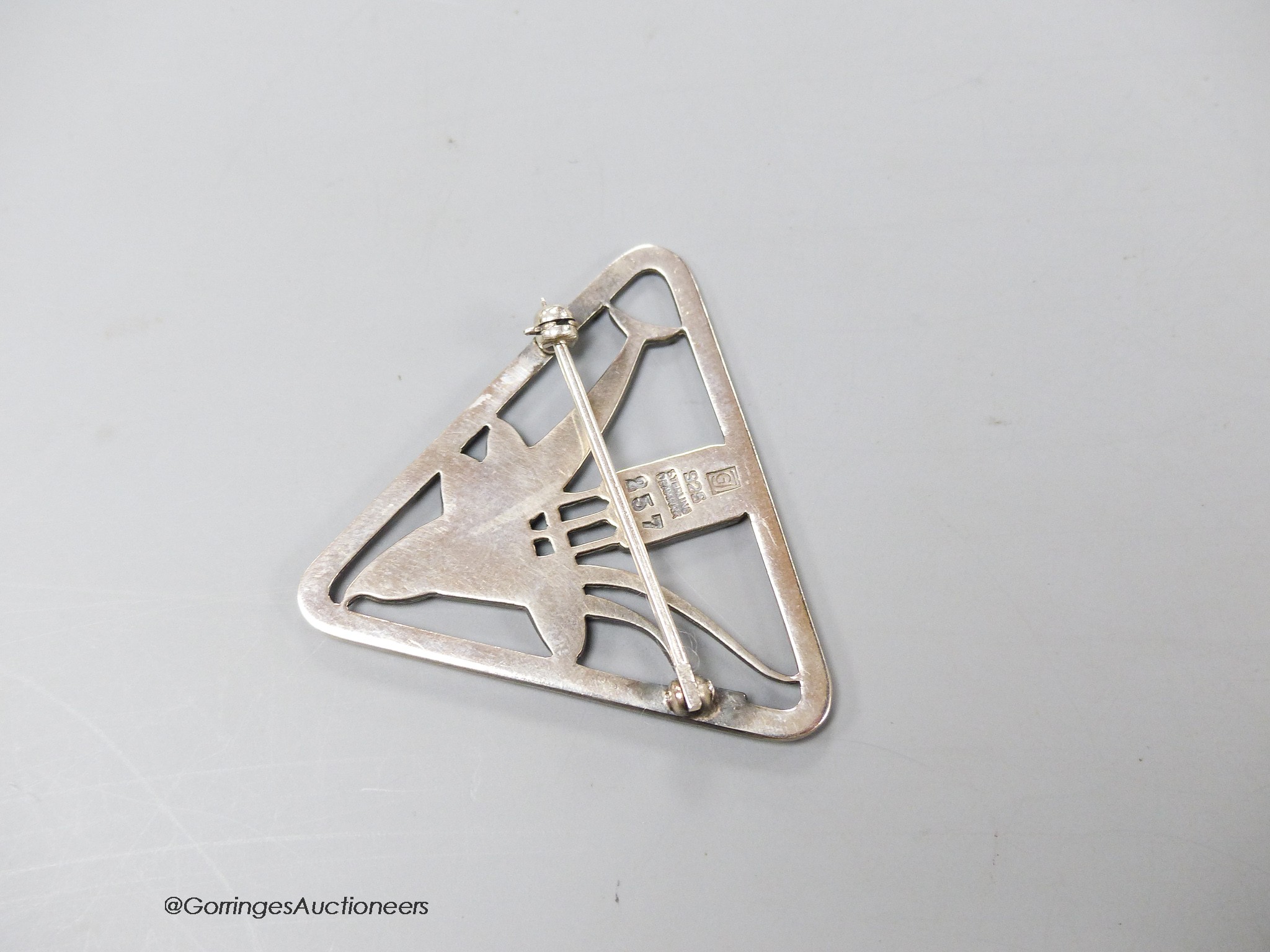 A Georg Jensen sterling dolphin and bulrush triangular brooch, no. 257, designed by Arno Malinowski, 37mm.